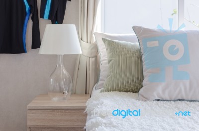 Modern Glass Lamp On Wooden Side Table In Bedroom Stock Photo