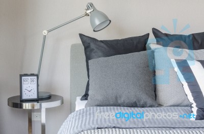 Modern Grey Lamp With Alarm Clock On Side Table In Bedroom Stock Photo