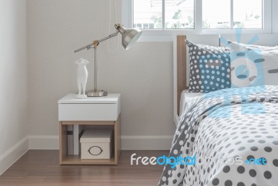 Modern Lamp On Bedside Table With Wooden Bed Stock Photo