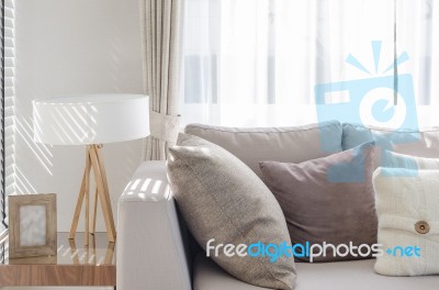 Modern Living Room With Sofa And Wooden Lamp On Table Side Stock Photo