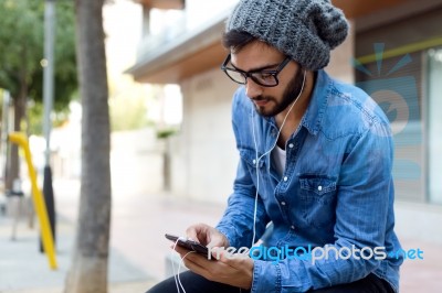 Modern Young Man With Mobile Phone In The Street Stock Photo