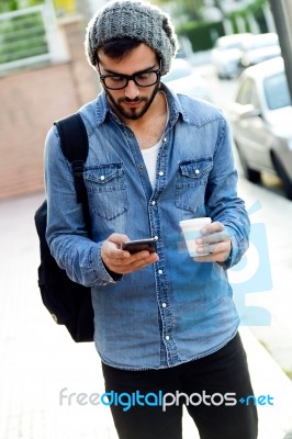 Modern Young Man With Mobile Phone In The Street Stock Photo