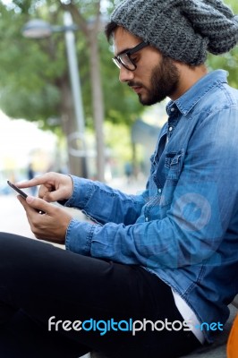 Modern Young Man With Mobile Phone In The Street Stock Photo