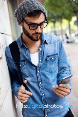 Modern Young Man With Mobile Phone In The Street Stock Photo