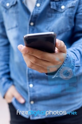 Modern Young Man With Mobile Phone In The Street Stock Photo