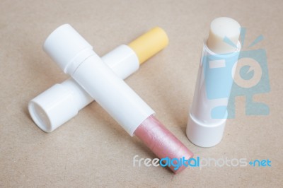 Moisturizer Lipstick On Brown Natural Background Stock Photo