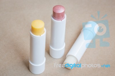 Moisturizer Lipstick On Brown Natural Background Stock Photo