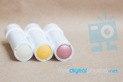 Moisturizer Lipstick On Brown Natural Background Stock Photo