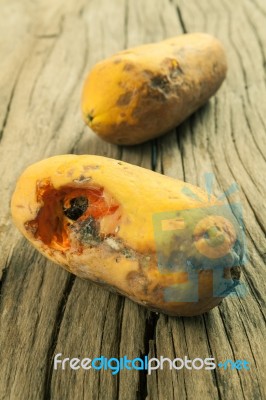 Moldy Papaya Fruit On Wood Background Stock Photo