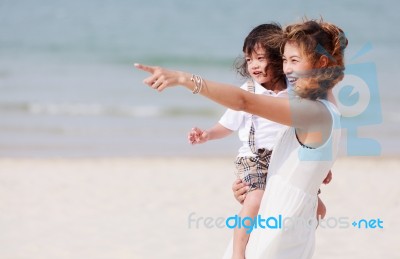 Mom And Son Play On Beach Stock Photo