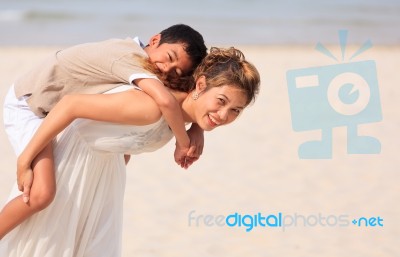 Mom And Son Play On Beach Stock Photo