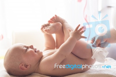 Mom Carefully Clean Baby Skin With Wet Wipes Stock Photo