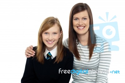 Mom Posing With Arms Around Her Cute Daughter Stock Photo