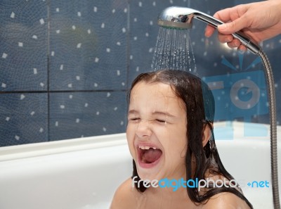 Mom Pours A Little Girl Out Of The Shower Stock Photo