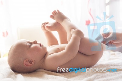 Momy Cleaning Baby Skin With Wet Wipes Stock Photo