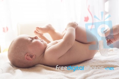 Momy Cleaning Baby Skin With Wet Wipes Stock Photo