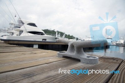 Mooring Bollard With Boats In The Background Stock Photo