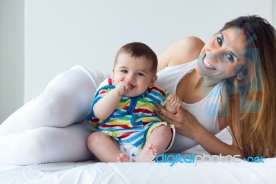 Mother And Baby Playing And Smiling At Home Stock Photo