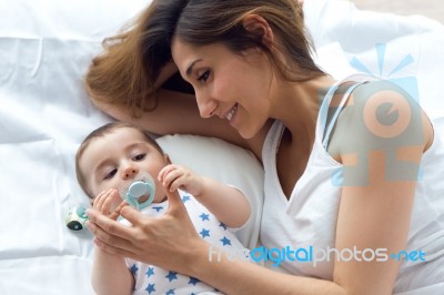 Mother And Baby Playing And Smiling At Home Stock Photo