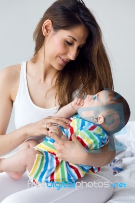 Mother And Baby Playing And Smiling At Home Stock Photo