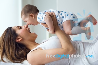 Mother And Baby Playing And Smiling At Home Stock Photo