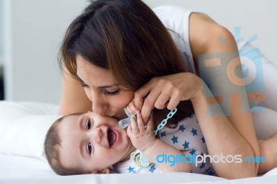 Mother And Baby Playing And Smiling At Home Stock Photo