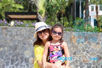 Mother And Daughter Enjoying The Summer Outdoors With Fancy Sung… Stock Photo