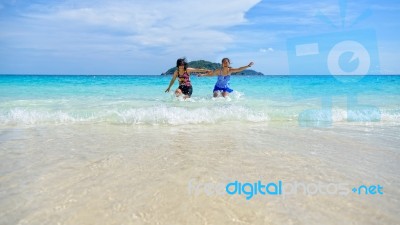 Mother And Daughter Happy On The Beach Stock Photo