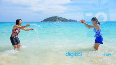 Mother And Daughter Happy On The Beach Stock Photo