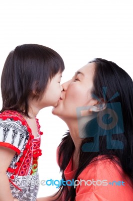 Mother And Daughter Kissing On White Background. Mothers Day Stock Photo