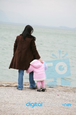 Mother And Daughter Looking Sea Stock Photo