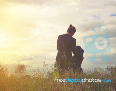 Mother And Daughter On Sunset Watching On Sky Stock Photo