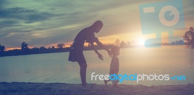 Mother And Daughter On Sunset Watching On Sky Stock Photo