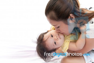 Mother And Her Baby In Action On White Background Stock Photo