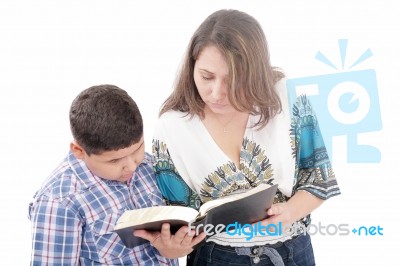 Mother And Son Reading A Bible Over A Black Background Stock Photo