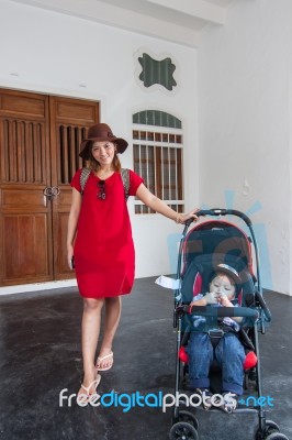 Mother And Son Standing At The House Stock Photo