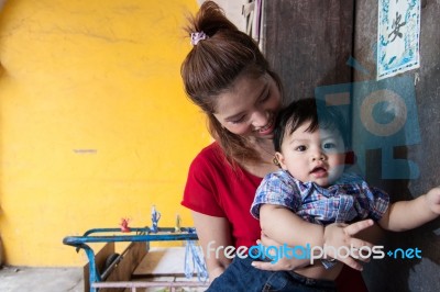 Mother And Son Standing At The House Stock Photo