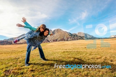 Mother Carries Daughter On Her Back  In Durmitor, Montenegro Stock Photo