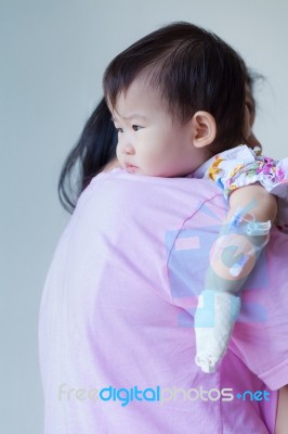 Mother Carrying Sick Baby In Hospital Stock Photo