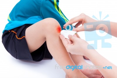 Mother Clean And Provides First-aid At Wound Stock Photo