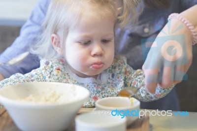 Mother Feeding Porridge Her Child, Healthy Breakfast Stock Photo