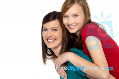 Mother Giving Daughter Ride On Back Stock Photo