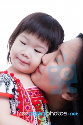 Mother Kissing Her Adorable Little Daughter Cheek, On White. Stu… Stock Photo