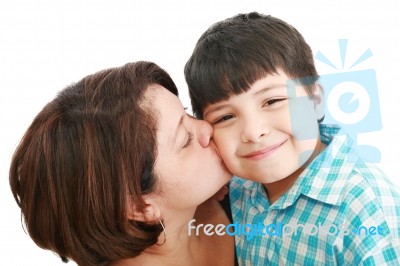 Mother Kissing Her Son Stock Photo