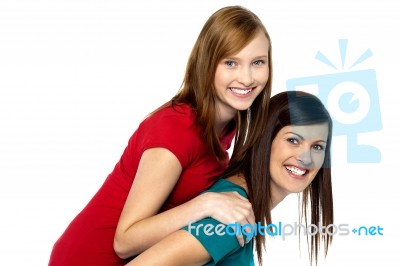 Mother Piggybacks Her Teenage Girl Stock Photo