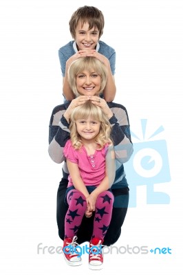 Mother Posing With Her Adorable Son And Daughter Stock Photo