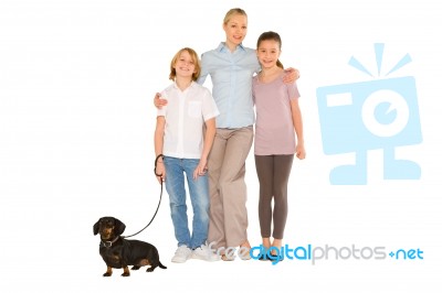 Mother Son Daughter Standing And Smiling With Small Dog Stock Photo