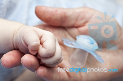 Mother's Hand Baby's Hand And His First Dummy Stock Photo