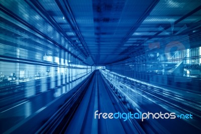 Motion Blur Of Automatic Train Moving Inside Tunnel In Tokyo, Japan Stock Photo