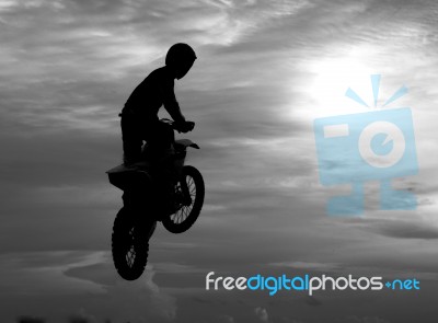 Motocross Rider Jumping Happily. While Floating In The Sky Like Stock Photo